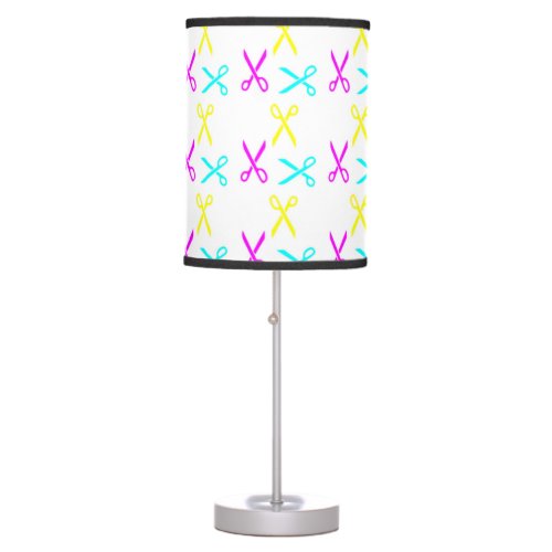 Colorful scissors on white table lamp