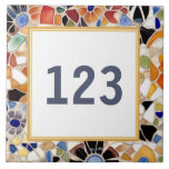 Colorful Spanish Mosaic House Door Number Sign Ceramic Tile<br><div class="desc">Please note: This is a faux mosaic. It is a printed graphic giving the illusion of mosaic stones. "custom house number plate", "personalized house no plaque", "personal customized text sign", "modern abstract design ceramic tile", "multicolored colorful gaudi mosaic", "building home apartment door", "bright vibrant yellow blue", "fun beautiful mediterranean mexican",...</div>