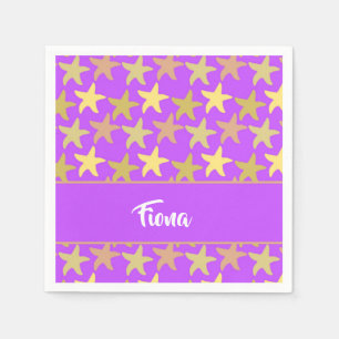Colorful starfish on purple napkins