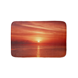 Colorful sunrise at sea, dramatic clouds. bath mat