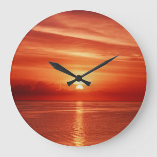 Colorful sunrise at sea, dramatic clouds. large clock