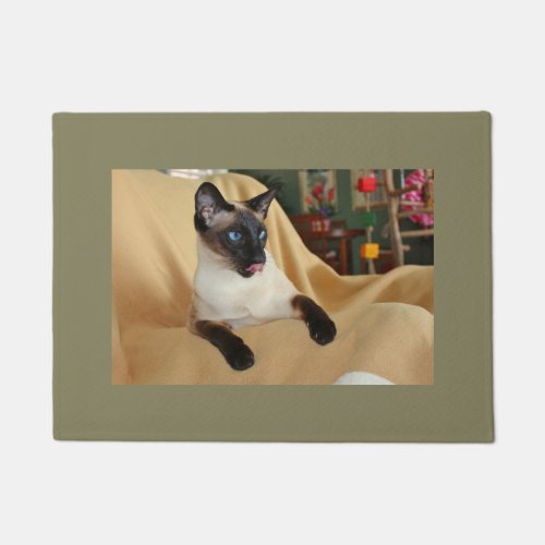 Comical Seal Point Siamese Cat Licking Its Nose Doormat