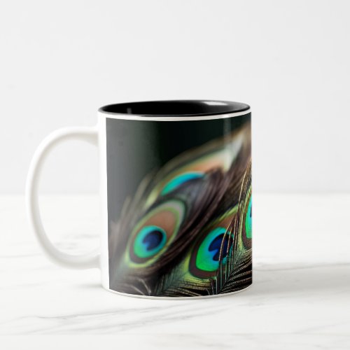 Composition of bright peacock feathers Two_Tone coffee mug