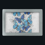 Composition of White and Blue Butterflies Belt Buckle<br><div class="desc">Vertical composition of realistic,  blue and white morpho butterflies on gray textured background. Morpho blue butterfly.</div>