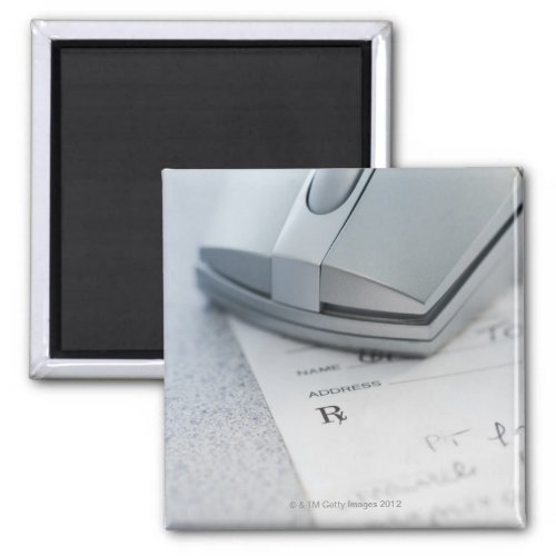 Computer mouse on written prescription magnet