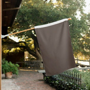 Confidently Against a Stylish Brown Wall House Flag