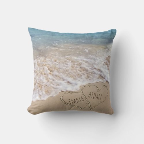 connected hearts in beach sand with ocean surf throw pillow