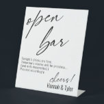 Contemporary Handwriting Funny Open Bar Pedestal Sign<br><div class="desc">This collection features an elegant, modern, handwritten font to create key words and phrases. In this piece, graphic typography overlays simply read "open bar" at the top and "cheers!" at the bottom. This option includes the popular message "Tonight's drinks are free. Tomorrow's stories will be priceless... (and well-documented.) Proceed accordingly."...</div>