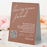 Contemporary Honeymoon Fund QR Code Terracotta Table Tent Sign<br><div class="desc">This collection features an elegant, modern, handwritten font to create key words and phrases. In this piece, the graphic typography overlays read "honeymoon fund" in the large header area and "with love & gratitude" before your names. Use the template fields to update your personal gratitude note and names. Feel free...</div>