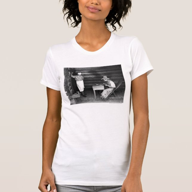 Cook watching a cowboy play cards T-Shirt (Front)