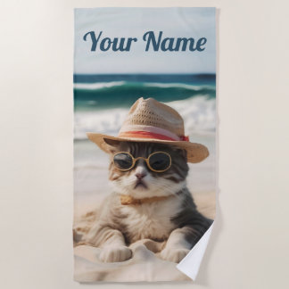Cool cat on the beach with sunglasses and hat. towel