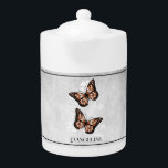 Copper Butterfly Floral Teapot<br><div class="desc">Enjoy your tea with a Copper Butterfly Floral Personalized Teapot.  Teapot design features a pair of vibrant butterflies resting on a white floral vine against a light gray grunge background. Additional gift items available with this design as well as a variety of colors.</div>