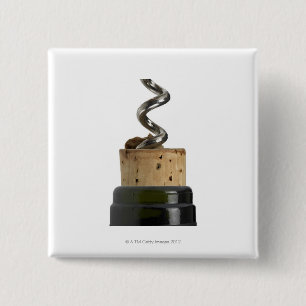 Corkscrew and cork, photographed on white button