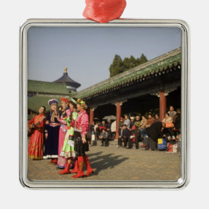 Costumed amateur folk dancers entertain metal ornament