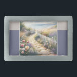 Cottage Garden Path to the Sea Belt Buckle<br><div class="desc">This dreamy watercolor captures a sunlit stone path winding through a lush cottage garden bursting with roses, foxglove, and lavender, leading to a serene beach at low tide. Soft waves shimmer beneath a pale sky, while a cozy bench and wicker basket tucked among white picket fences add a sense of...</div>
