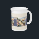Cottage Garden Path to the Sea Beverage Pitcher<br><div class="desc">Tailor the inside sentiment to fit your personal needs. This dreamy watercolor captures a sunlit stone path winding through a lush cottage garden bursting with roses, foxglove, and lavender, leading to a serene beach at low tide. Soft waves shimmer beneath a pale sky, while a cozy bench and wicker basket...</div>
