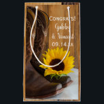 Country Sunflower Congratulations Western Wedding Small Gift Bag<br><div class="desc">Fill the charming Country Sunflower Congratulations Western Wedding Gift Bag with your present for the newlywed bride and groom. These casual yet classy custom rustic chic ranch style wedding congrats bags feature a quaint floral photograph of a yellow sunflower blossom and brown leather cowboy boots with a brown barn wood...</div>