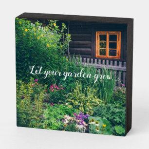 Countryside house with a colorful garden wooden box sign
