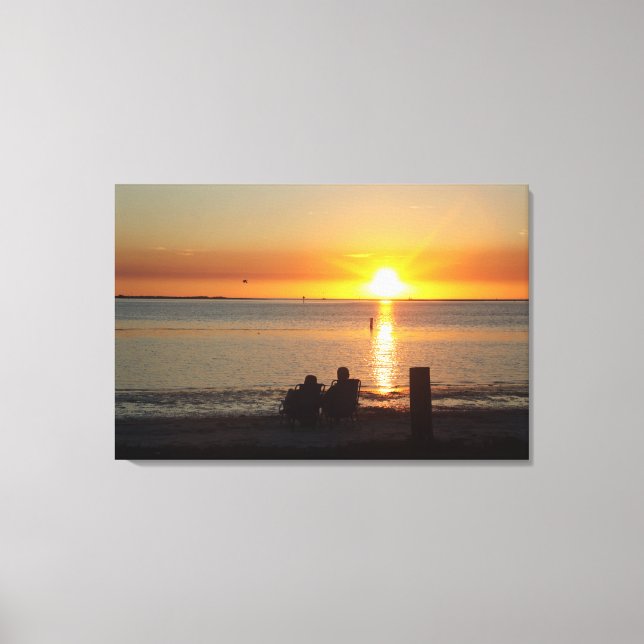 Couple Sit On Beach At Sunset Canvas Print (Front)