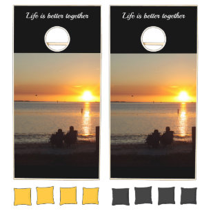 Couple Sit On Beach At Sunset Cornhole Set