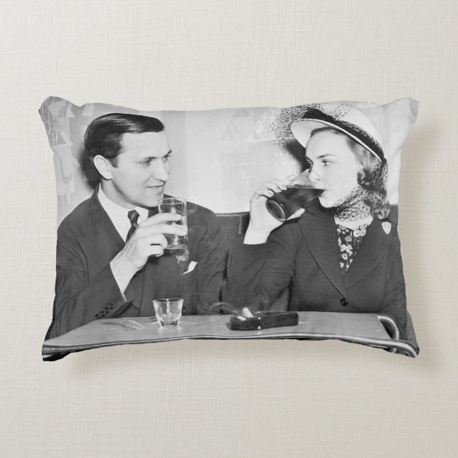 Couple sitting together in a restaurant flirting w accent pillow (Front)