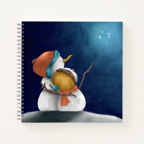 Couple snowmen hugging looking at the stars wish notebook