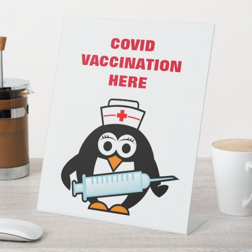 Covid vaccination counter desk sign with cartoon