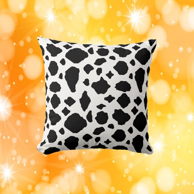 Cow Print Pattern Black and White Throw Pillow (A throw pillow with a black and white cow pattern)