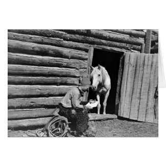 Cowboy and a horse looking at a letter cards