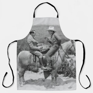 Cowboy and businessman playing checkers on horseba apron