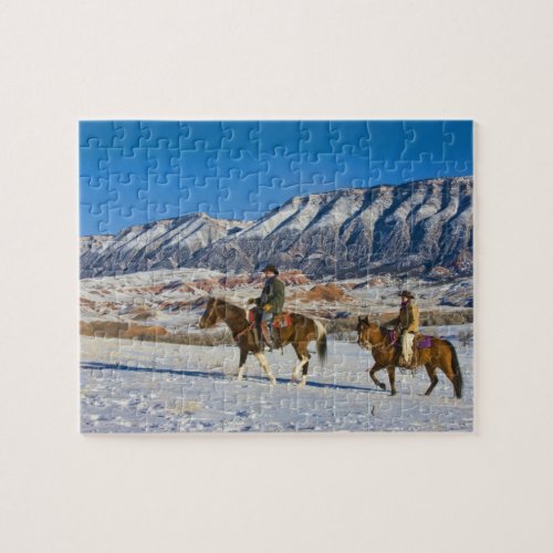 Cowboy and Cowgirl riding Horse through the Snow Jigsaw Puzzle