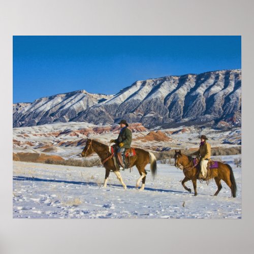 Cowboy and Cowgirl riding Horse through the Snow Poster