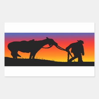 Cowboy at sunset rectangular sticker