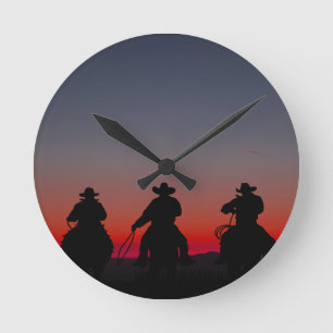 cowboy at sunset round clock