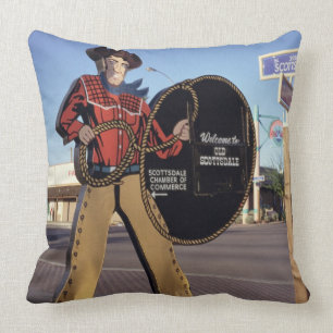 Cowboy figure sign welcoming tourists to Scottsdal Throw Pillow