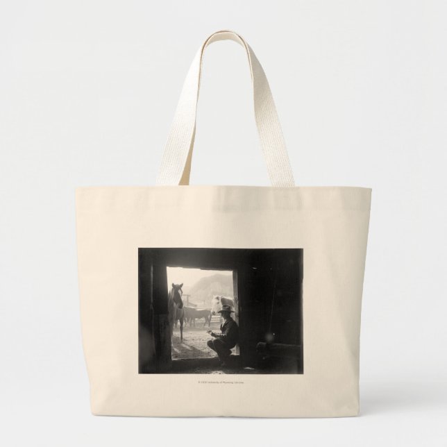 Cowboy in a doorway with horses large tote bag (Front)