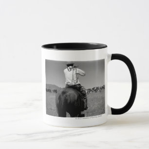 Cowboy on a horse with two brands. mug