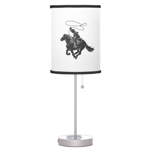 Cowboy on bucking horse running with lasso table lamp