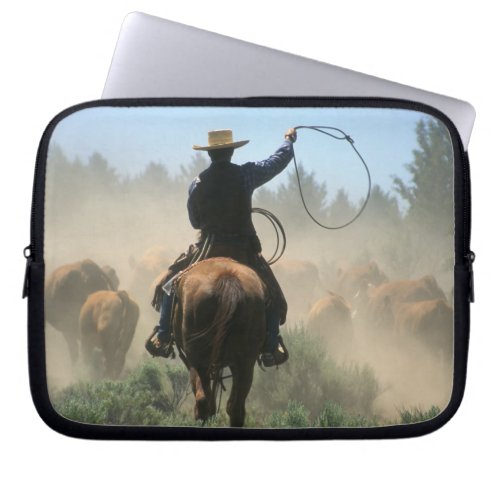 Cowboy on horse with lasso driving cattle laptop sleeve
