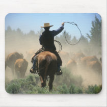 Cowboy on horse with lasso driving cattle mouse pad