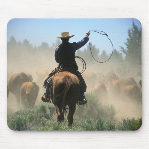 Cowboy on horse with lasso driving cattle mouse pad