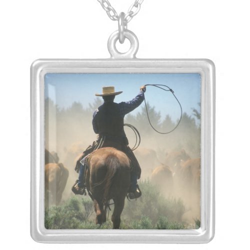 Cowboy on horse with lasso driving cattle silver plated necklace