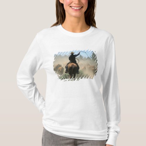 Cowboy on horse with lasso driving cattle T_Shirt