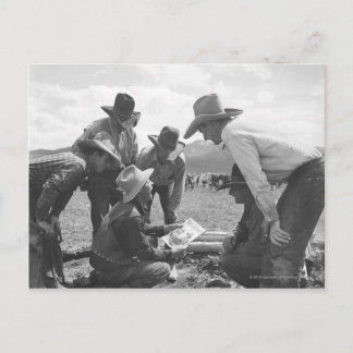 Cowboys looking a magazine postcard