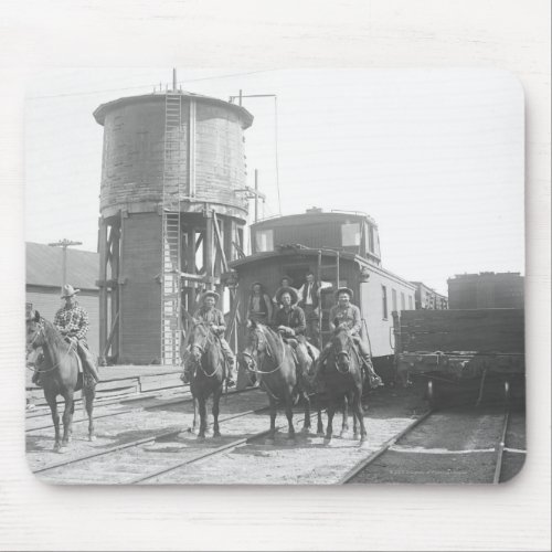 Cowboys on horses posing in front of a train mouse pad