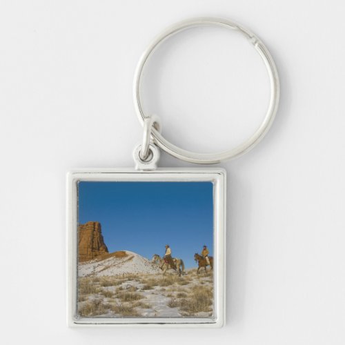 Cowboys on Ridge riding Horse through the Snow Keychain