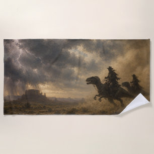 Cowboys Riding Dinosaurs Through a Desert Storm Beach Towel
