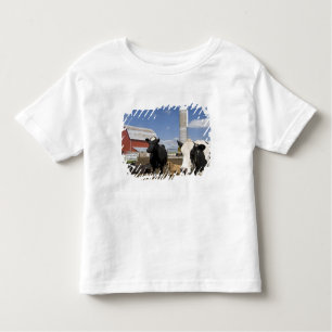 Cows in front of a red barn and silo on a farm toddler t-shirt