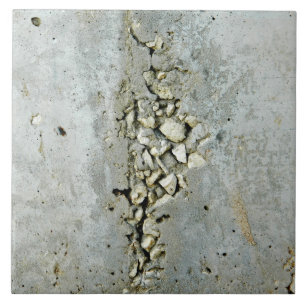 Cracked concrete wall with small stones ceramic tile