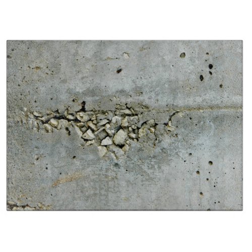 Cracked concrete wall with small stones cutting board